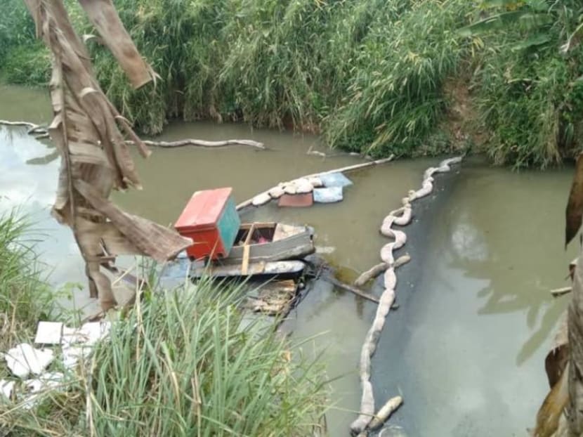 Oil booms seen on part of the Kim Kim River in Pasir Gudang on March 8, used to stop toxic waste from floating further down river.