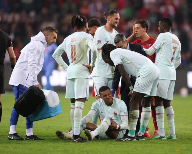 France's Mbappe forced off with apparent knee injury in Turkey clash