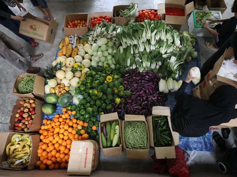 Vegetables rescued from Pasir Panjang Wholesale Market being laid out before distribution to beneficiaries in Yishun.