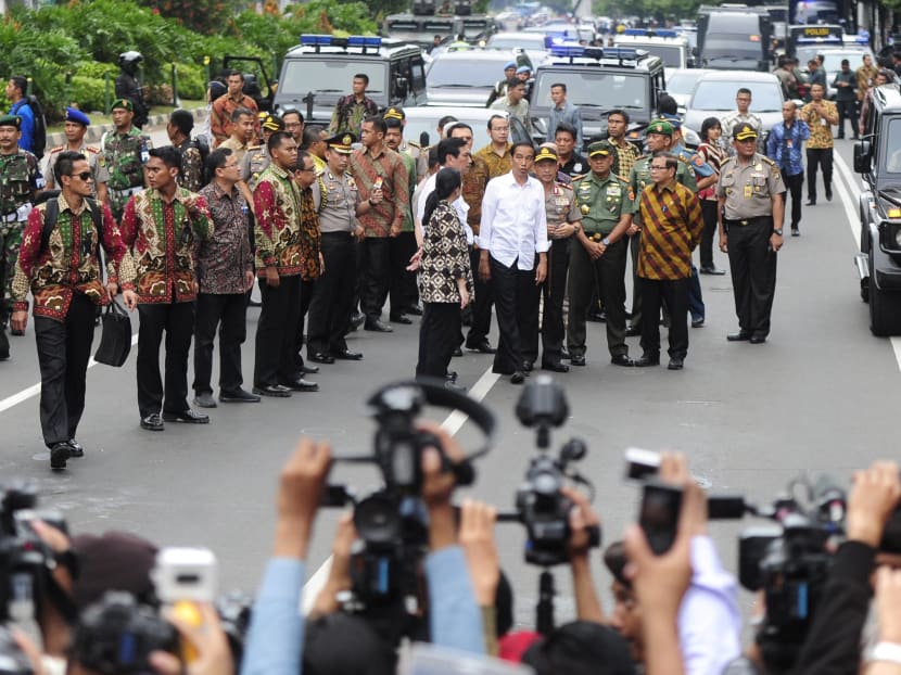 Seven dead in Jakarta blasts, gunfight