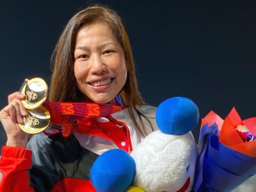 Underwater hockey player Christina Tham poses with her gold medals at the SEA Games 2019.