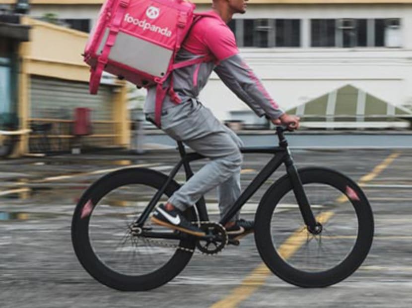 A Foodpanda delivery rider makes his rounds on a bicycle. A Foodpanda delivery rider makes his rounds on a bicycle.