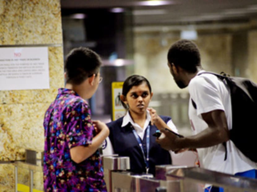 A security officer at Beauty World MRT Station yesterday informing two members of the public that transactions are not allowed in the premises. Under the Singapore Statutes, offenders may be removed from the stations or fined a maximum of S$2,000. Photo: Robin Choo