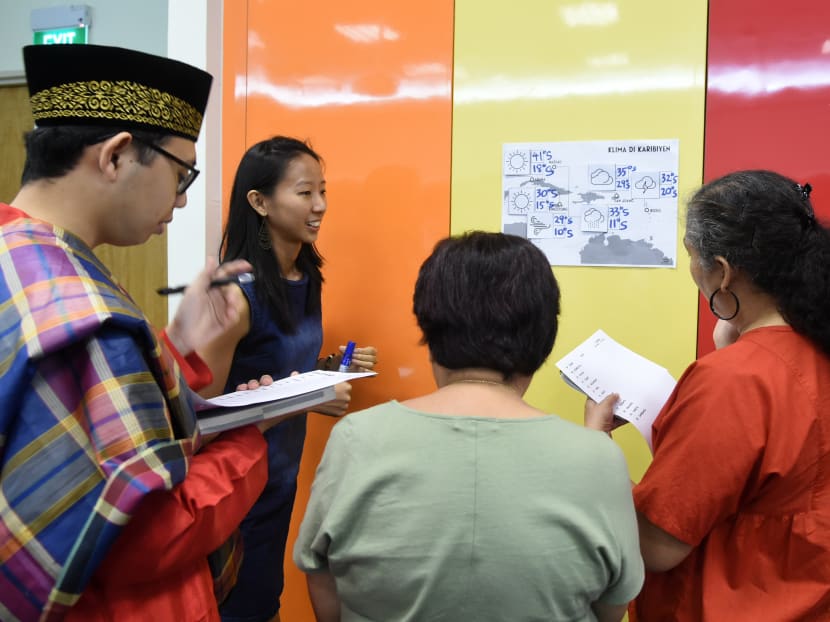 Students from various cultures in a group discussion during their Kristang language class session at the national library board in Singapore. Photo: AFP