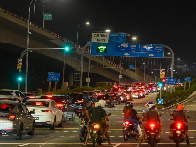 Vehicles form a long queue to enter the Woodlands Checkpoint in Singapore early on April 1, 2022, before crossing the causeway to Malaysia's southern Johor state, as both countries reopen its borders to all fully vaccinated travellers. Vehicles form a long queue to enter the Woodlands Checkpoint in Singapore early on April 1, 2022, before crossing the causeway to Malaysia's southern Johor state, as both countries reopen its borders to all fully vaccinated travellers.