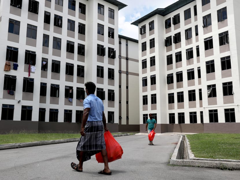 A foreign worker in Tampines Dormitory returns to his room with the catered lunch for his roommates. In its statement on Sunday, the Ministry of Health said that the vast majority of the new Covid-19 cases are work permit holders who are residing in dormitories.