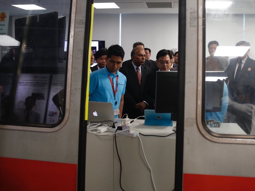 Finance Minister Heng Swee Keat at the Advanced Train Door Sensor System, which is one of the 13 projects rolled out by SMRT-NTU Corporate Lab, to improve rail reliability.