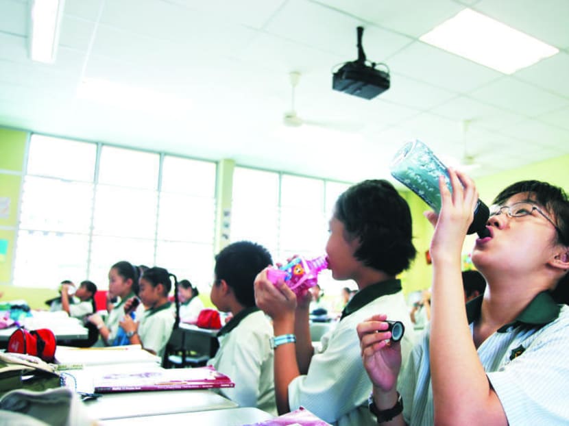 Students drinking water in the class room. TODAY file photo