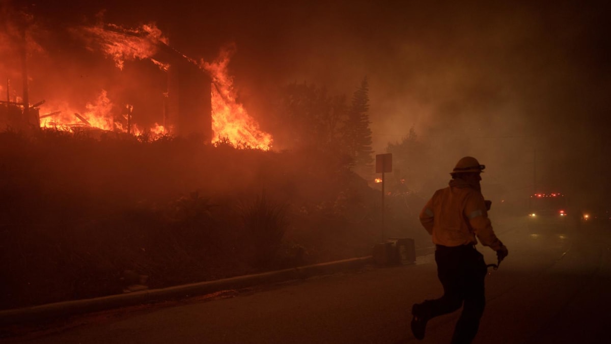 Wildfire sparks panicked evacuations in Los Angeles suburb