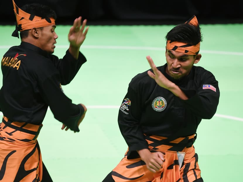Mohamad Taqiyuddin bin Hamid and Rosli bin Mohamad Sharif of Malaysia perform during the Pencak Silat double final at the 29th Southeast Asian Games (SEA Games) in Kuala Lumpur on August 24, 2017. Photo: AFP Mohamad Taqiyuddin bin Hamid and Rosli bin Mohamad Sharif of Malaysia perform during the Pencak Silat double final at the 29th Southeast Asian Games (SEA Games) in Kuala Lumpur on August 24, 2017. Photo: AFP