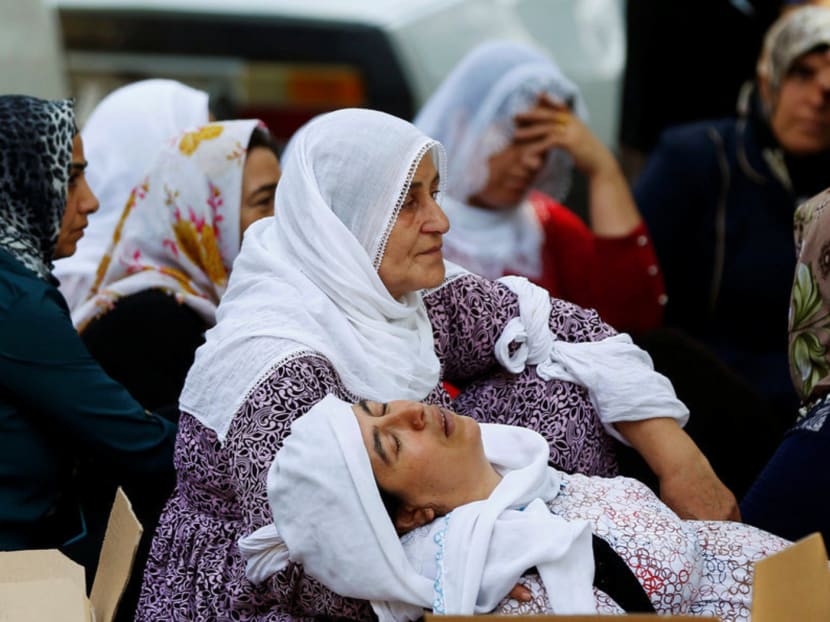 Women waiting outside a hospital morgue for word of missing relatives after a bomber targeted a wedding 

celebration in the Turkish city of Gaziantep yesterday. The bride and groom survived the attack. Photo: Reuters