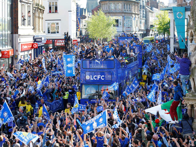 Leicester City celebrate with the trophy on the bus during their victory parade. Photo: Reuters
