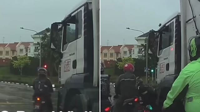 摩托车马路停垃圾车前险遭辗