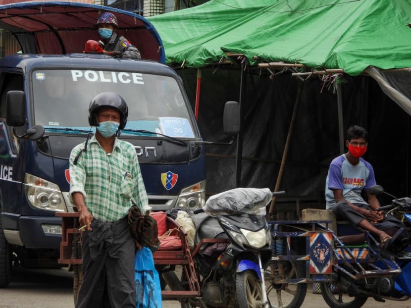 A police watches over from a vehicle while people wear face masks on a street during a lockdown in Sittwe, capital of Rakhine State, southern Myanmar, Aug 23, 2020. A police watches over from a vehicle while people wear face masks on a street during a lockdown in Sittwe, capital of Rakhine State, southern Myanmar, Aug 23, 2020.