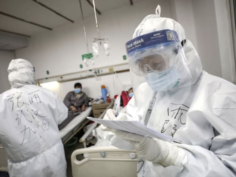 A medical worker in a protective suit checks a patient’s records at Jinyintan hospital in Wuhan, the epicentre of the Covid-19 outbreak, in Hubei province, China on Feb 13, 2020.
