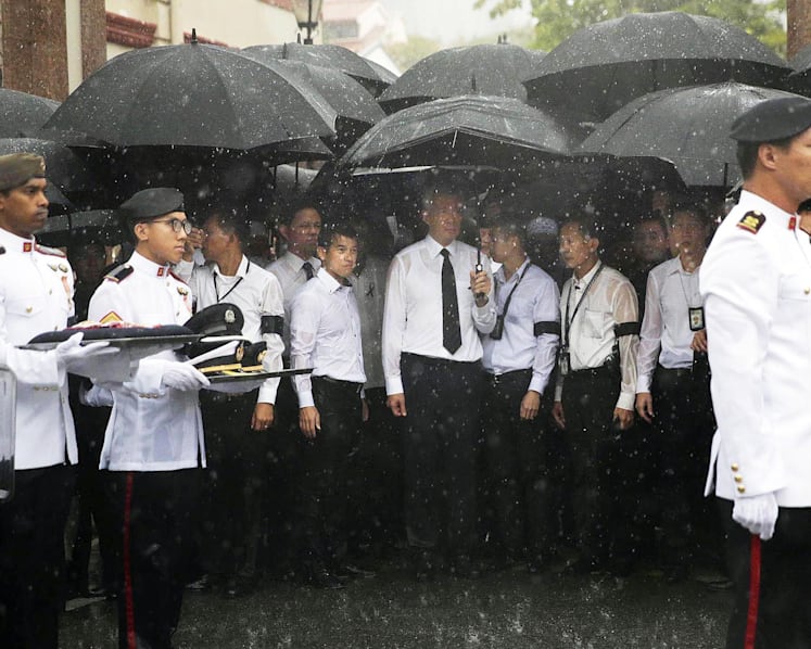 Crowds brave torrential downpour as Othman Wok is laid to rest