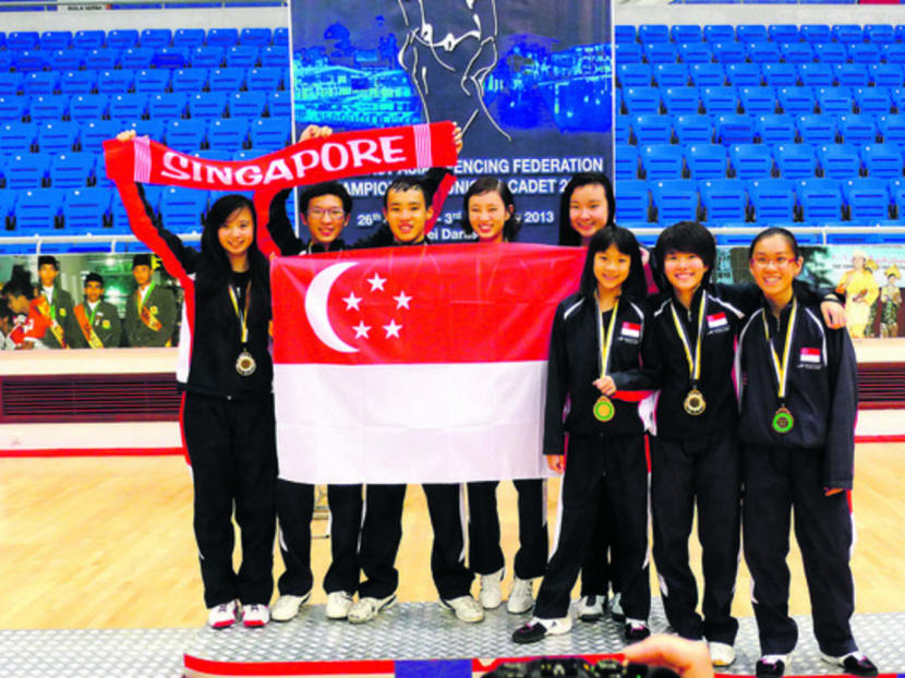 (From left) Fencers Christabel Yong, Christian Lim, Joshua Lim, Donna Lim, Rania Rahardja, Lau Ywen, Felicia Yam and Jolie Lee celebrating Team Singapore’s golden start at the SEAFF Junior and Cadet Championships 2013. Photo: Fencing Singapore