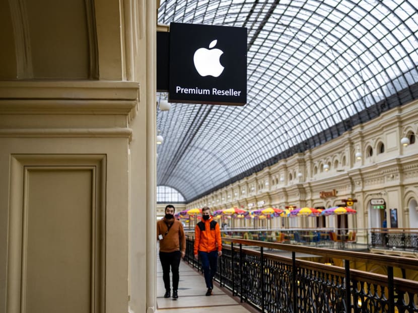 People pass by an Apple store at the State Department Store, GUM, in central Moscow on April 27, 2021.