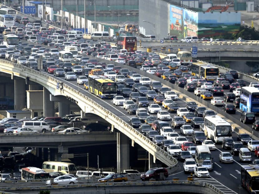 Rush-hour traffic on Guomao Bridge in Beijing in July 2013. In the past two years, city authorities have tried to curb the growing number of migrant workers to Beijing, also moving factories and major wholesale markets to the city’s outskirts or neighbouring Tianjin and Hebei. Photo: Reuters