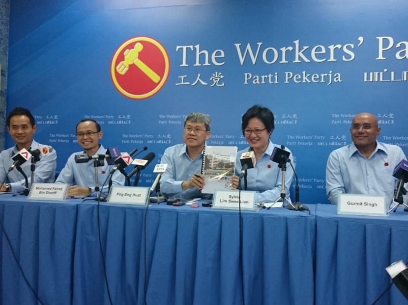 At today's (Aug 30) unveiling the Workers' Party's fourth batch of candidates, Sylvia Lim and Png Eng Huat held up the Aljunied Hougang Punggol East Town Council FY14/15 financial report, which they said will be submitted tomorrow. Photo: Lee Yen Nee/TODAY