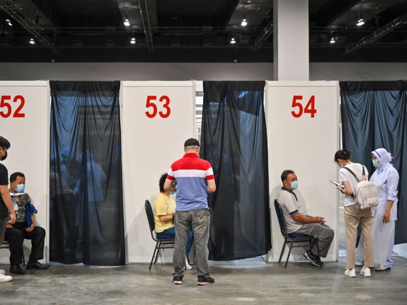 People wait to receive a dose of the Pfizer-BioNTech Covid-19 coronavirus vaccine during the first mega Covid-19 vaccination at the Malaysia International Trade and Exhibition Centre in Kuala Lumpur on May 31, 2021.

