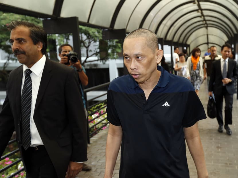 Alleged match-fixer Dan Tan Seet Eng, leaving the Supreme Court with his lawyers, after he was set free today (Nov 25) after a two year detention. Photo: Ernest Chua/TODAY