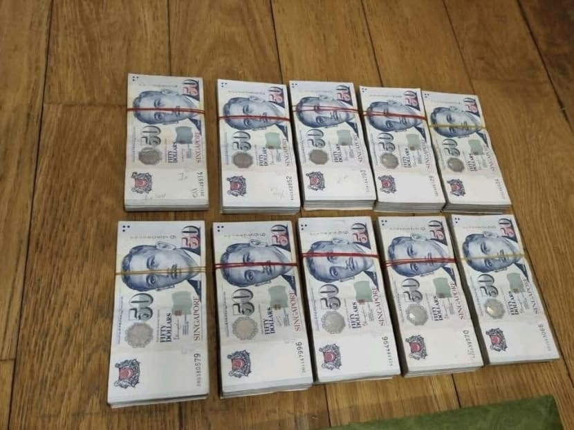 A photograph supplied by Singapore Police Force of cash seized during the raids.