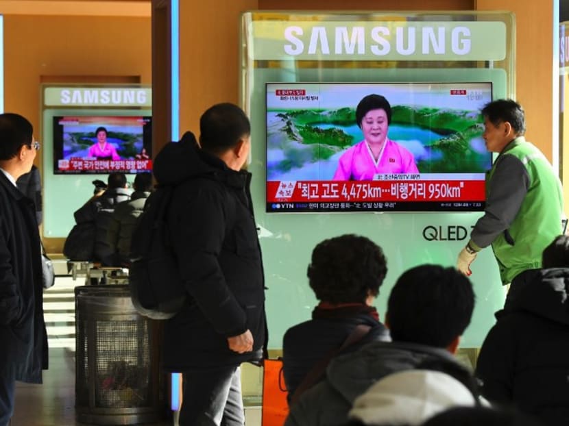 People watch a television news screen showing a North Korean announcer reading a statement on the country’s new ICBM test late last month. The United States, Japan and South Korea started joint exercises on Monday (Dec 11) as tensions rise in the region over North Korea’s fast-developing weapons programmes. Photo: AFP