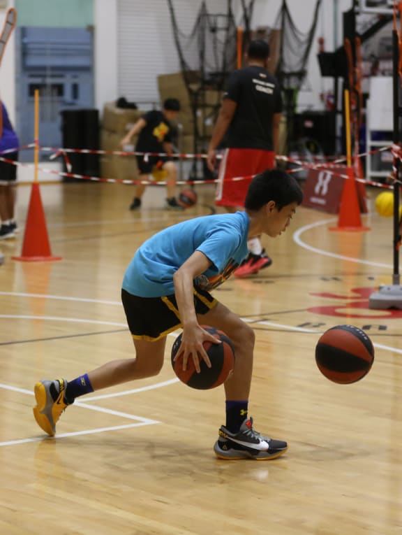 Youths are seen training at an indoor basketball court on Feb 6, 2022.