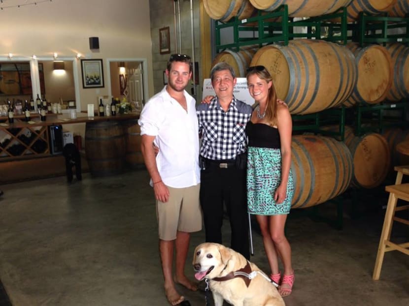 Singapore's first seeing eye-dog Kendra in the United States with owner Mr Kua Cheng Hock and her "puppy raiser mom". Photo: Kendra's Facebook page