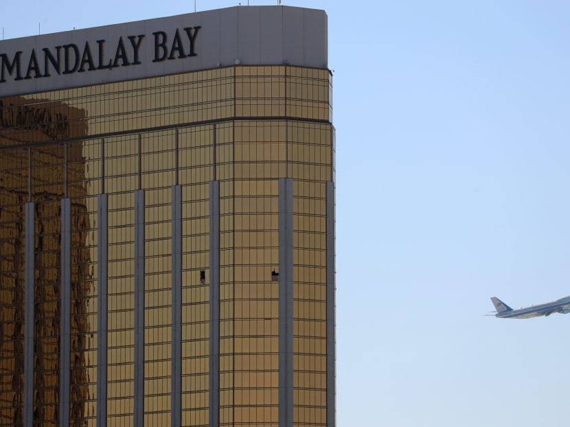 Air Force One departs Las Vegas past the broken windows on the Mandalay Bay hotel where shooter Stephen Paddock conducted his mass shooting along the Las Vegas Strip in Las Vegas, Nevada. Photo: Reuters