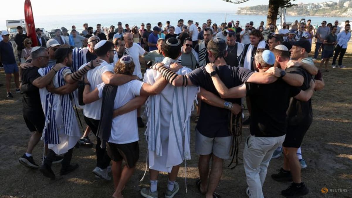 Australian Jews hold prayers, hundreds of surfers paddle out at Bondi to honour shooting victims