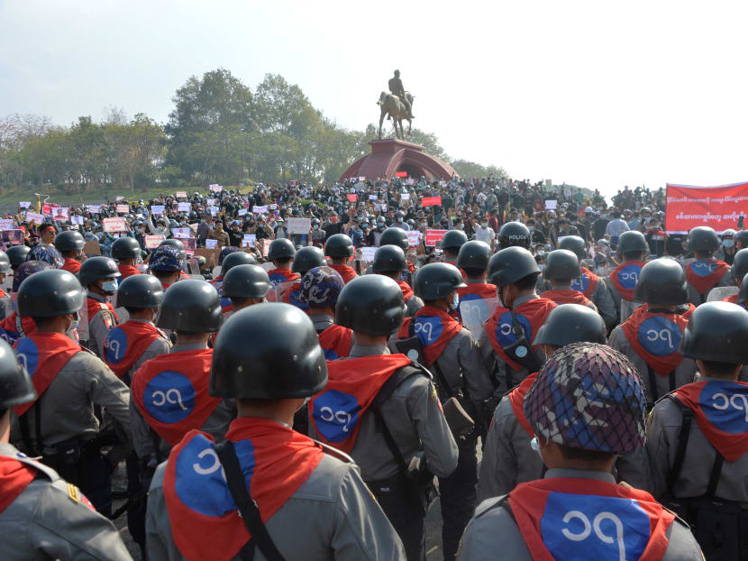 Phalanx of riot police face off protestors during a demonstration against the military coup at the monument of General Aung San (centre), the late father of Ms Suu Kyi in Naypyidaw on Feb 8, 2021.