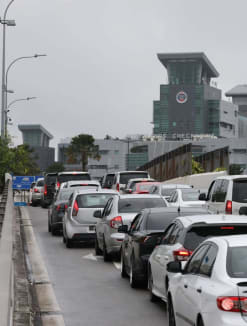 A file photo of a queue of cars heading towards Woodlands Checkpoint in January 2023.
