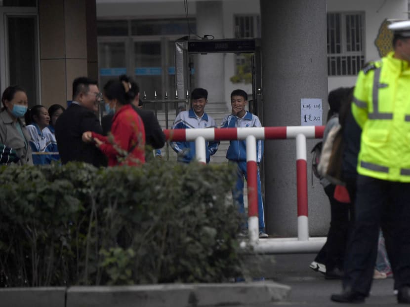 This photo taken on Sept 10, 2020 shows policemen standing guard as students arrive at the entrance to the Tongliao Mongolian Middle School in Tongliao in China's northern Inner Mongolia region, following recent protests over a new bilingual education policy by the Chinese government.