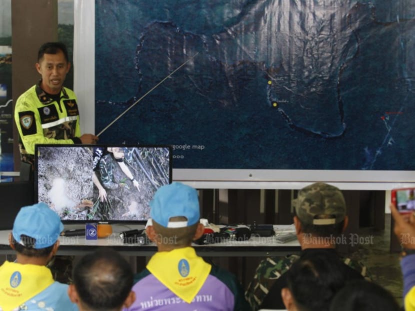 A park official shows the location where six wild elephants were found dead in Khao Yai National Park on Sunday (Oct 6). The bodies of five more were spotted in the same area on Tuesday.