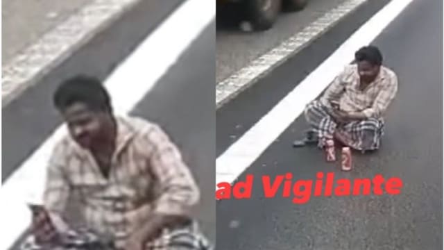 坐快速公路上喝酒玩手机 男子被捕