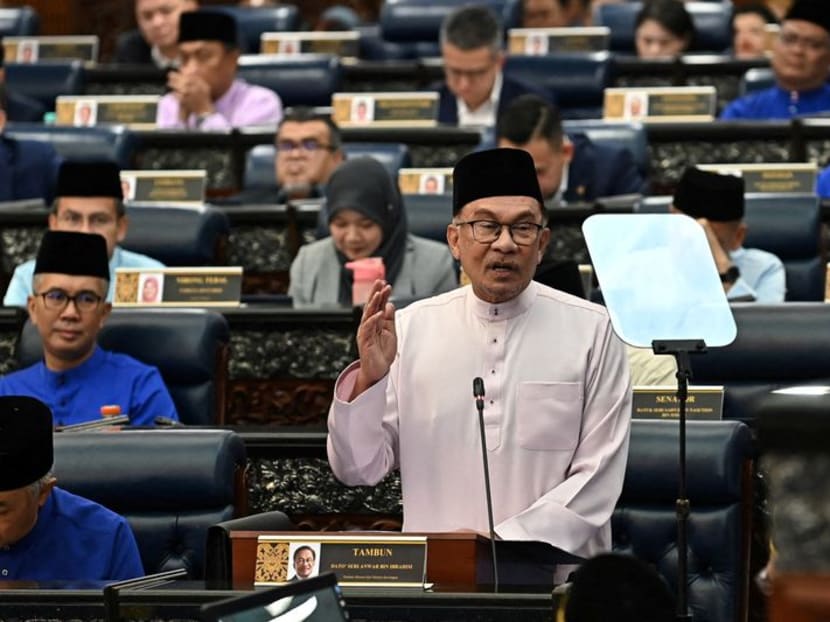 FILE PHOTO: Malaysia's Prime Minister and Finance Minister Anwar Ibrahim tables the 2024 Malaysia's budget at the Malaysian parliament, in Kuala Lumpur, Malaysia, October 13, 2023. Famer Roheni/Department of Information Malaysia/ Handout via REUTERS/ FILE PHOTO