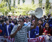 Timor-Leste police fire tear gas at protest over plan to buy cars for MPs