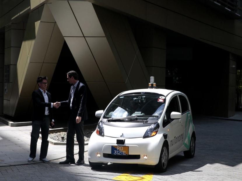 nuTonomy CEO Karl Iagnemma and head of Grab Singapore Lim Kell Jay next to a nuTonomy self driving car on Sept 23, 2016. Photo: Jason Quah