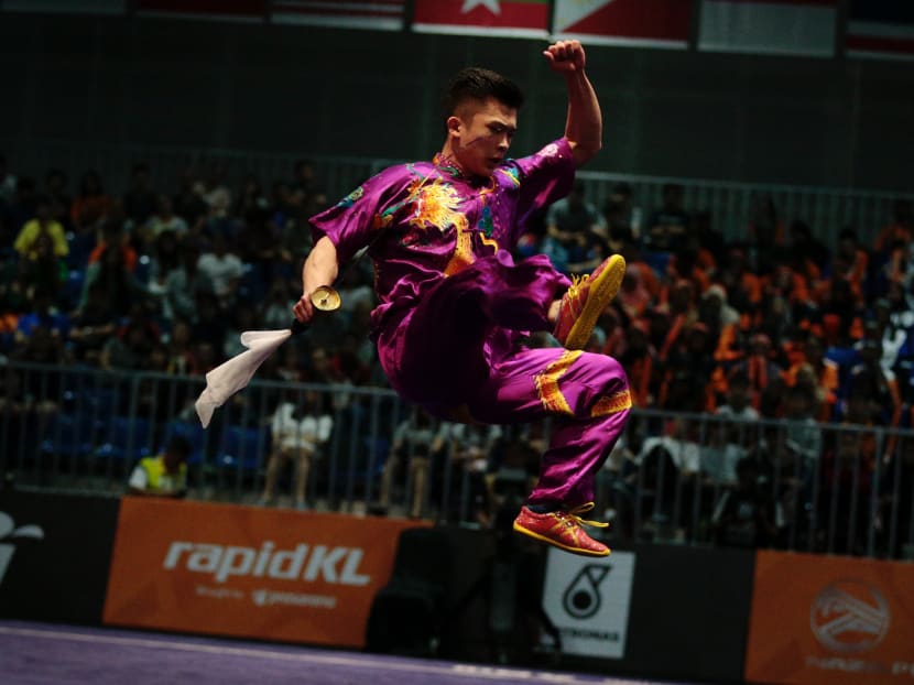 Jowen Lim wowed the crowd at the Kuala Lumpur Convention Centre with a stunning display of blade-work in the daoshu portion to score 9.69. Combined with his 9.68 for the gunshu on Sunday, it was enough to clinch the Republic’s first gold in the sport at this Games. Photo: Jason Quah / TODAY