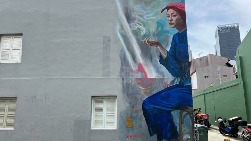 Plaque containing anti-smoking message installed at smoking samsui woman mural