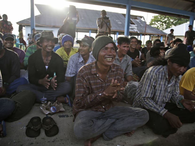 Recently rescued Cambodian fishermen clap their hands while singing after their arrival in Tual, Indonesia, on Saturday, April 4, 2015. Photo: AP