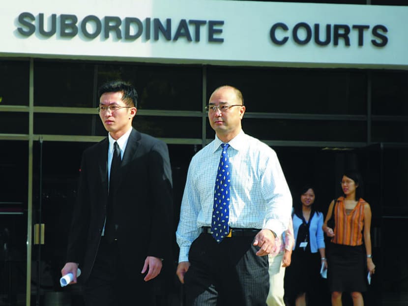 Mr Chen Jiulin (in light-coloured shirt) leaves the Subordinate Courts with his lawyer Jeffrey Yap after a pre-trial conference on June 17, 2005. Photo: Sng Li Wei