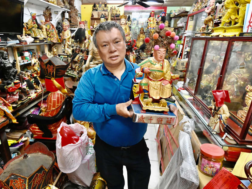 Sculptor Lin Hsin-lai displays a Taoist god statue at his workplace in Taoyuan, northern Taiwan, on March 17, 2020.