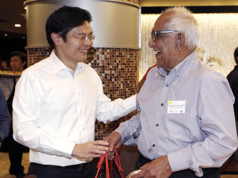 In this Oct 9, 2014 file photo, former hockey/cricket/football player Vijiaratnam Arumugam, right, and Lawrence Wong, then Minister for Culture,Community and Youth, talk at the opening of the Singapore Youth Olympic Museum and Singapore Sports Museum. Photo: Wee Teck Hian