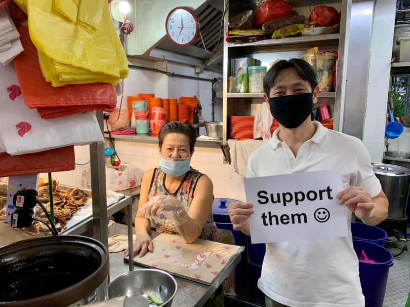 Member of Parliament Louis Ng holding up a sign urging Singaporeans to support their neighbourhood hawkers at Yishun Park Hawker Centre in June 2020.
Member of Parliament Louis Ng holding up a sign urging Singaporeans to support their neighbourhood hawkers at Yishun Park Hawker Centre in June 2020.