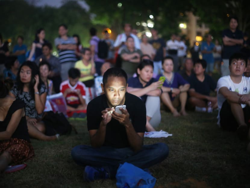 A man looking at his handphone at a Singapore People's Party rally on Sept 8, 2015. In light of the Covid-19 situation, analysts are expecting political parties to be delivering their messages online instead of holding outdoor rallies during campaigning for the coming General Election. A man looking at his handphone at a Singapore People's Party rally on Sept 8, 2015. In light of the Covid-19 situation, analysts are expecting political parties to be delivering their messages online instead of holding outdoor rallies during campaigning for the coming General Election.