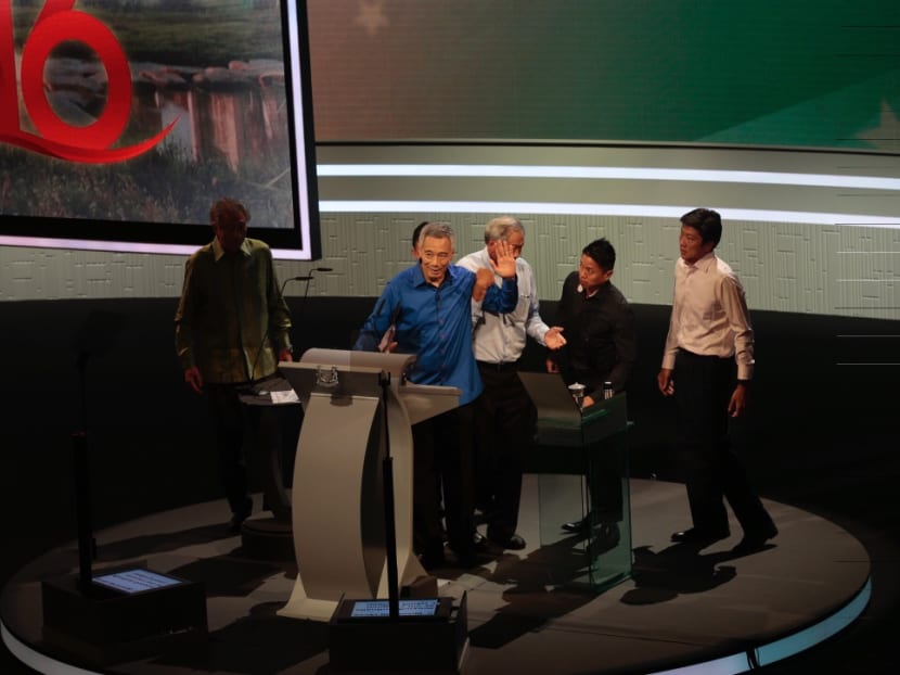 Prime Minister Lee Hsien Loong being helped on stage by ministers and security officers at the National Day Rally 2016. Photo: Jason Quah