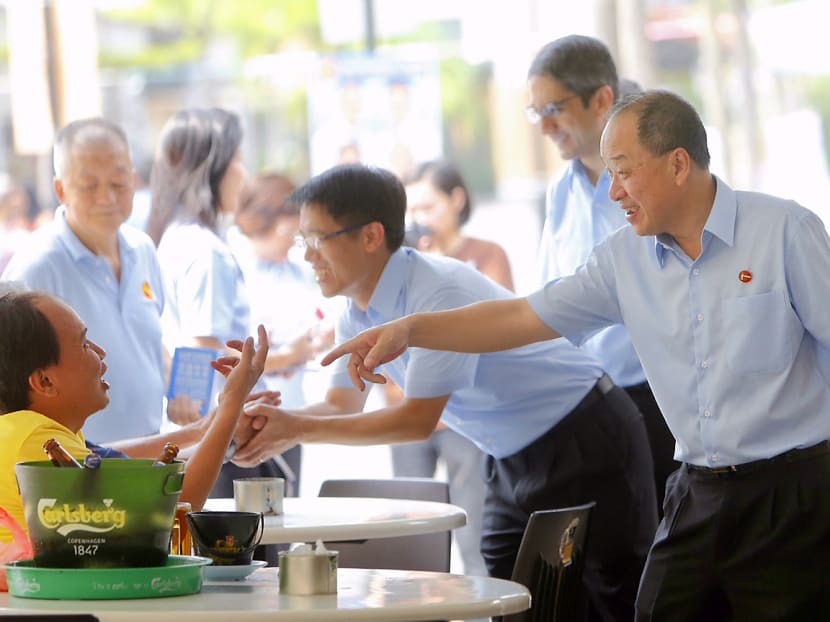 From right: The Workers’ Party’s Mr Low, Mr Perera and Mr Giam during a walkabout at New Upper Changi Road today. Mr Perera said the party is confident the minimum wage proposal will work because the level it is proposing is modest. Photo: Raj Nadarajan/TODAY